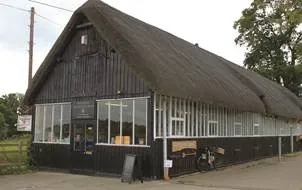 The Daffodil Barn: a long thatched timber barn