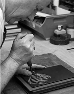 John Goss tooling a design in gold on a leather binding